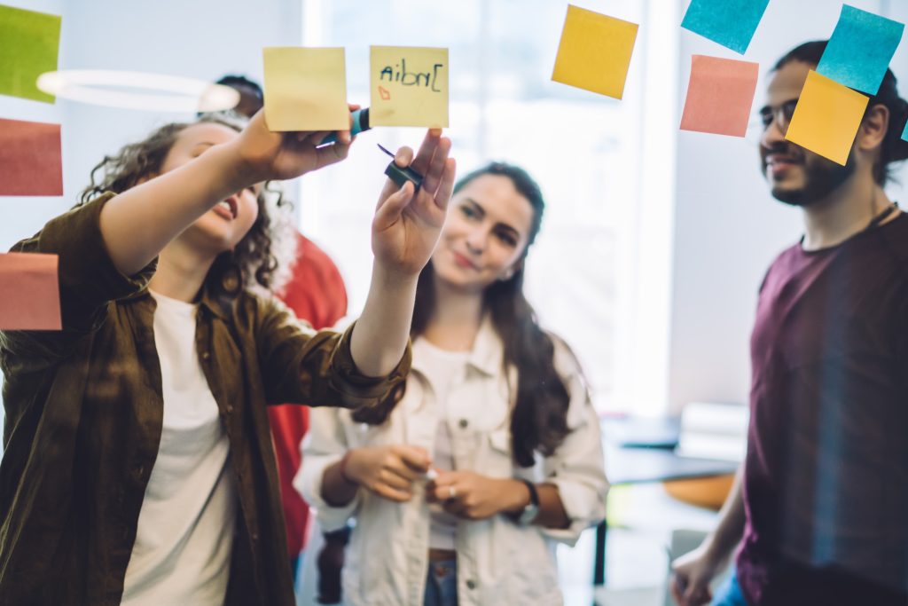 young students writing plan on notes